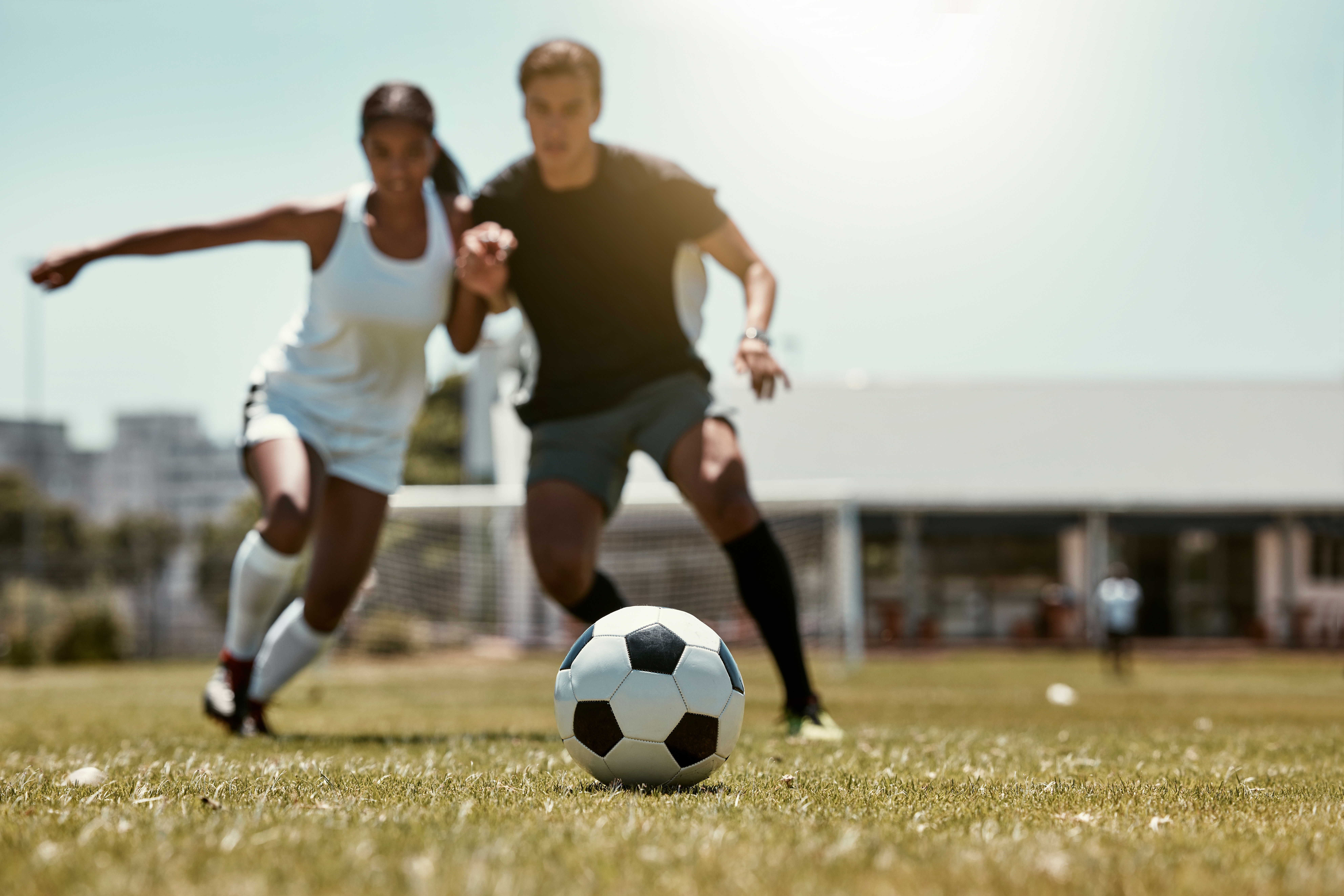Man and women play soccer together.