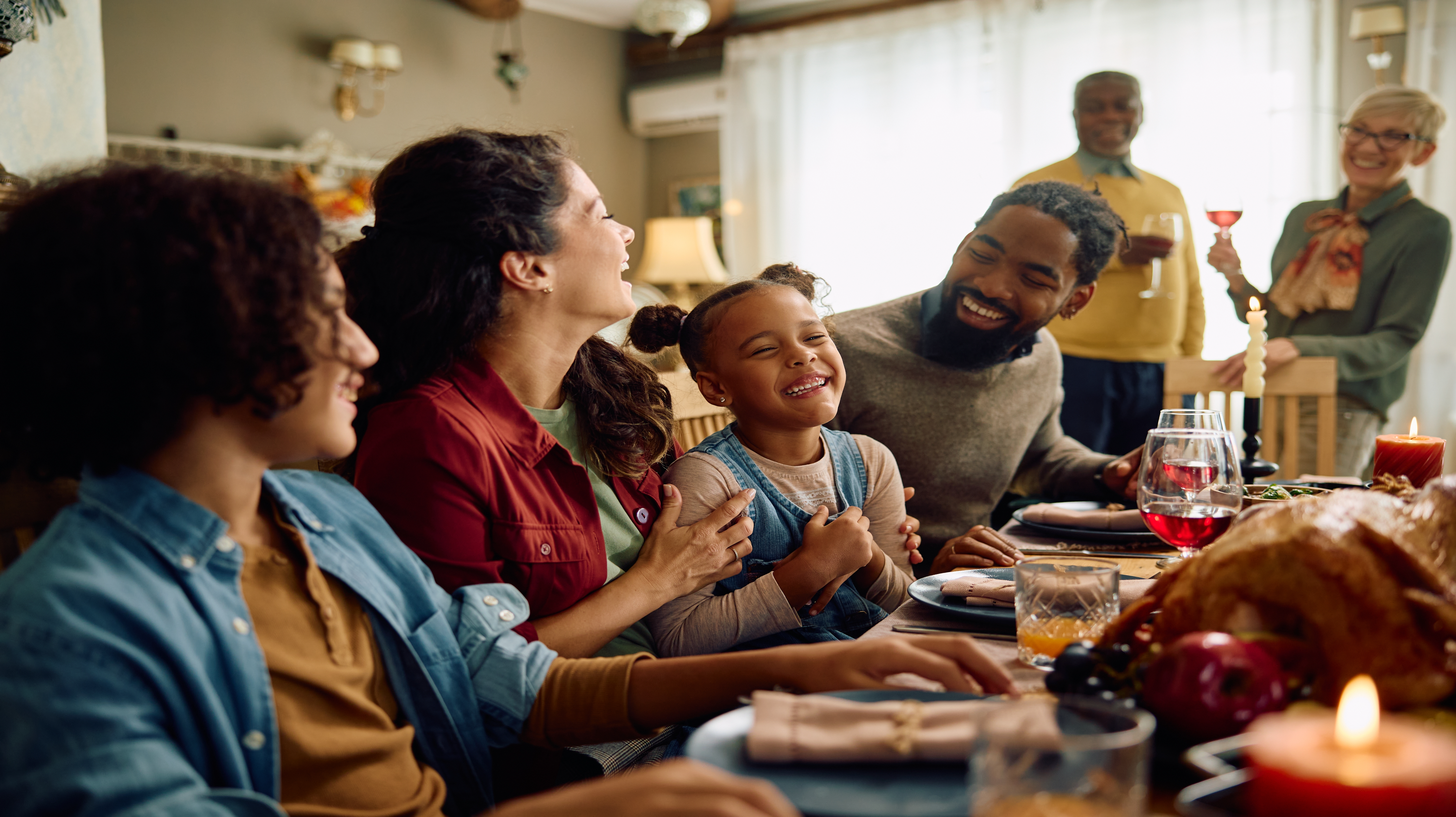Smiling family at holiday dinner table.